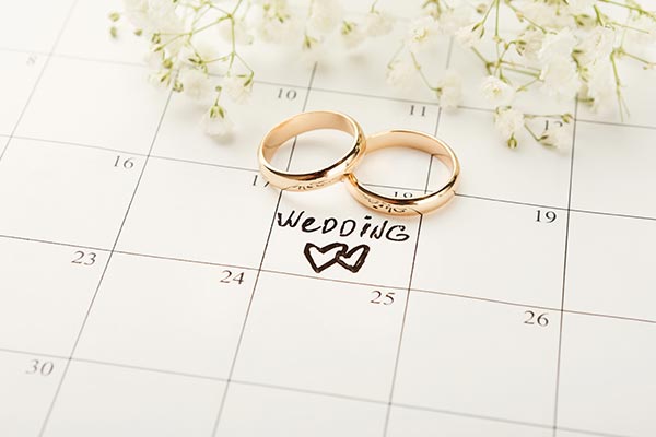 two wedding rings laying on planning calendar