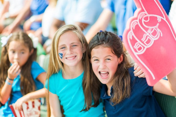 photo of two students at a pep rally in the stands