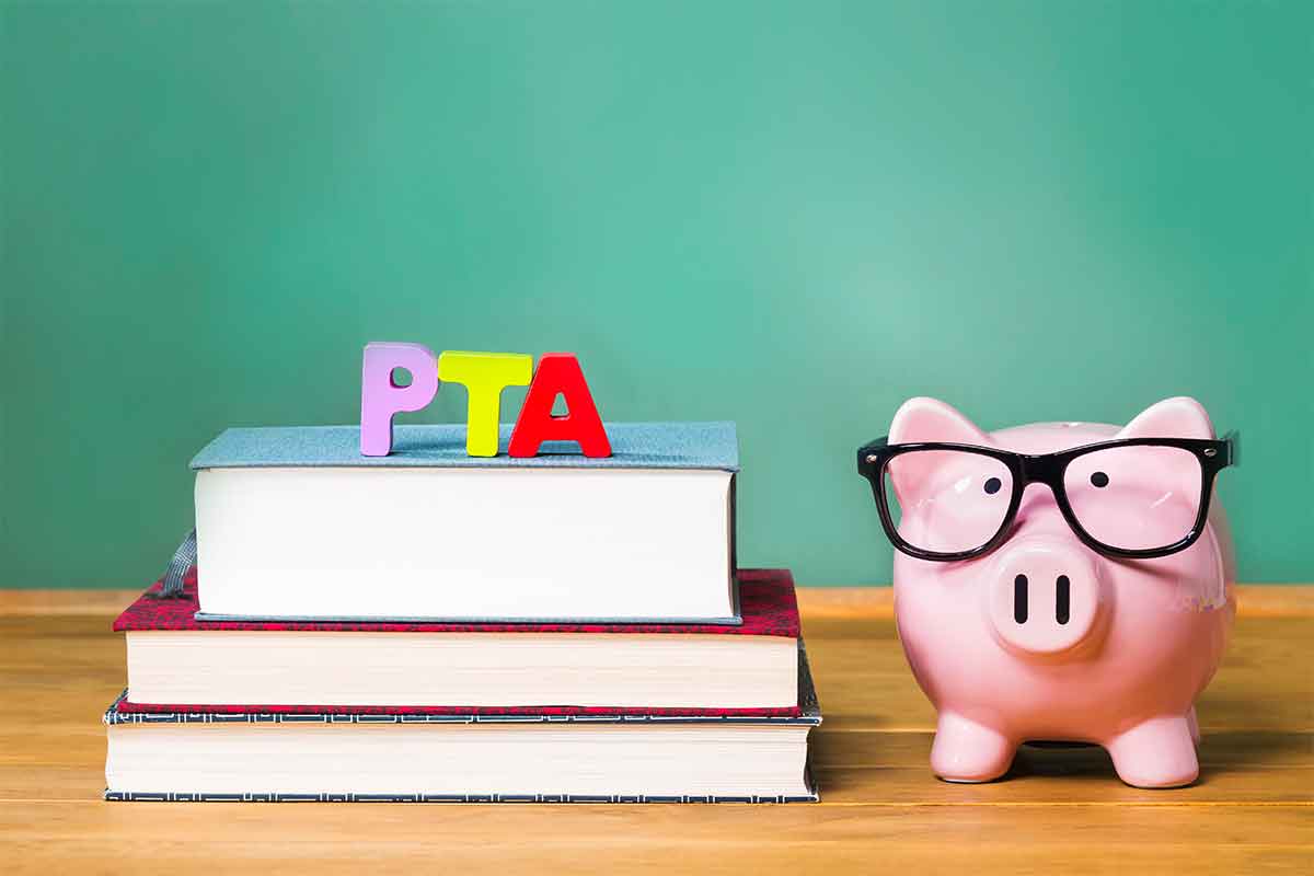 photo of piggy bank on top of books with PTA letters