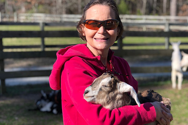 Woman holding goat