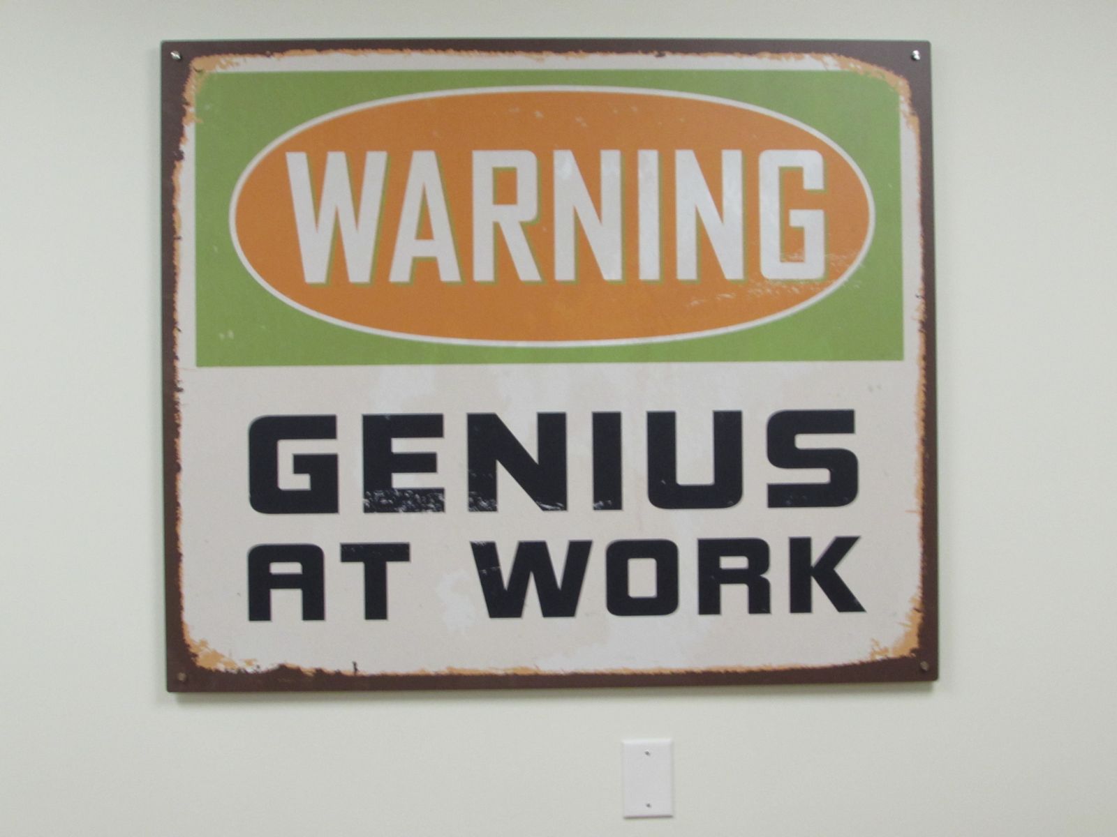 genius at work sign