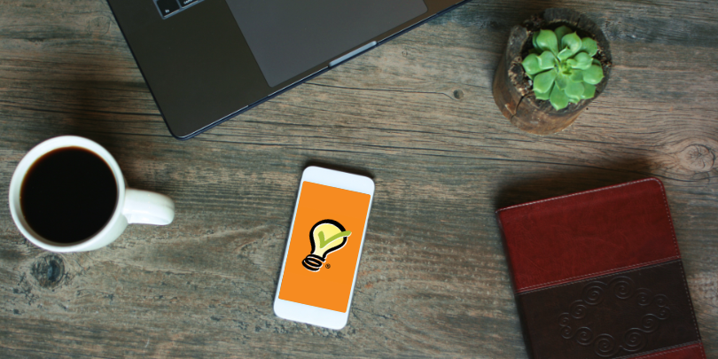 photo of bible and coffee on a table and a phone showing SignUpGenius logo