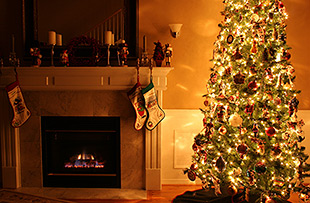 christmas tree and stockings by fireplace