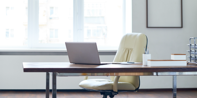 image of empty desk chair in an office