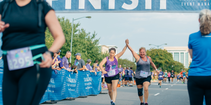 photo of two women crossing the finish line at an Isabella Santos fundraising run