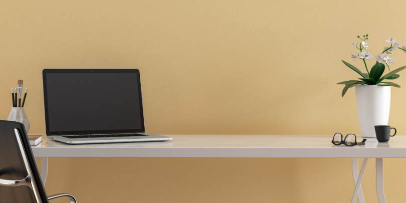 photo of desk against warm yellow brown background