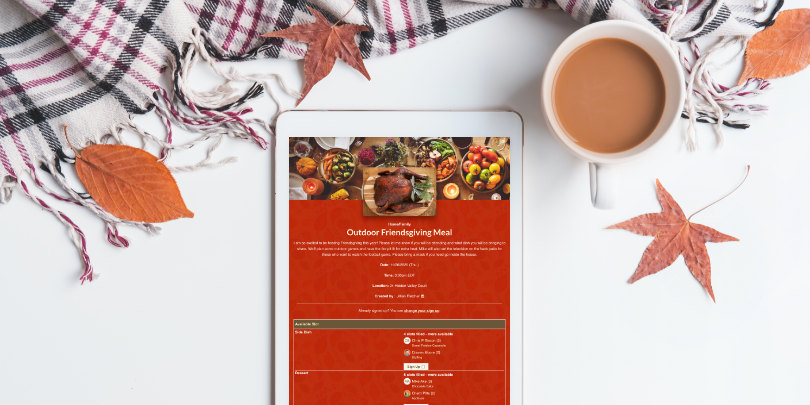 image of friendsgiving sign up showing on white iPad on white background with leaves coffee and a scarf