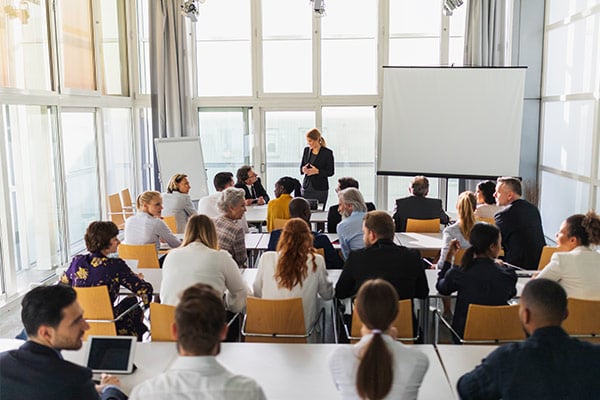 group of employees in a training together sitting at desks