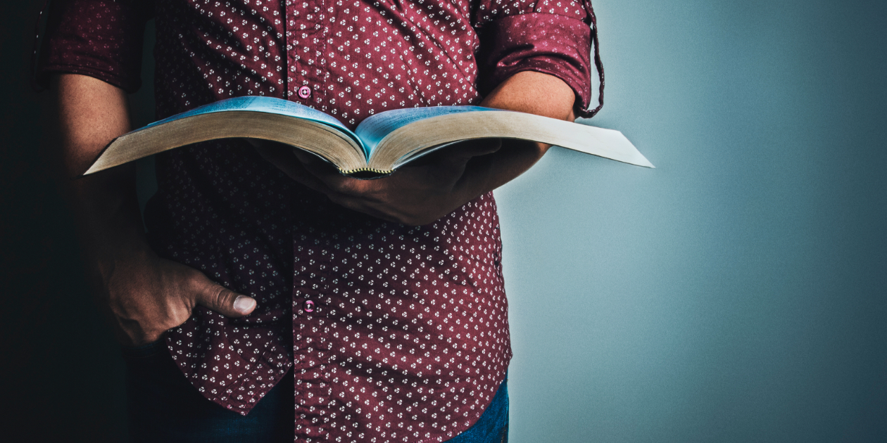 person holding a bible in their hands