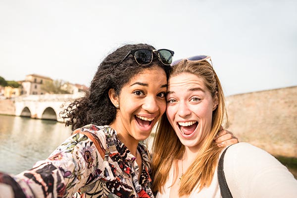 girls posing for picture on travels abroad