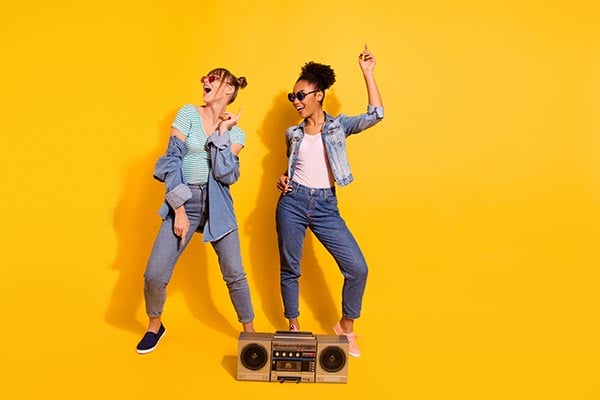 college kids dancing next to music speakers