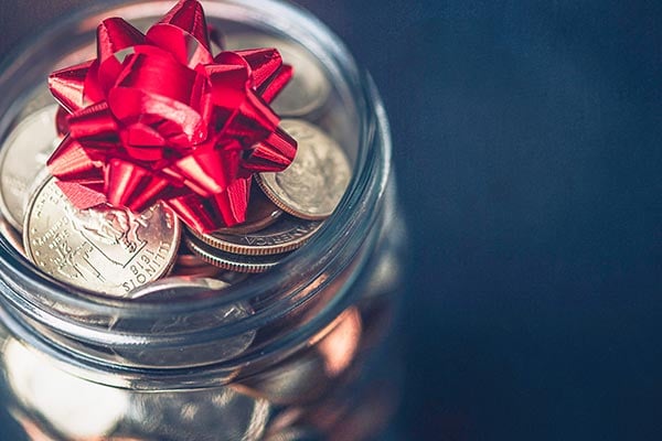 jar of coins with bow on top