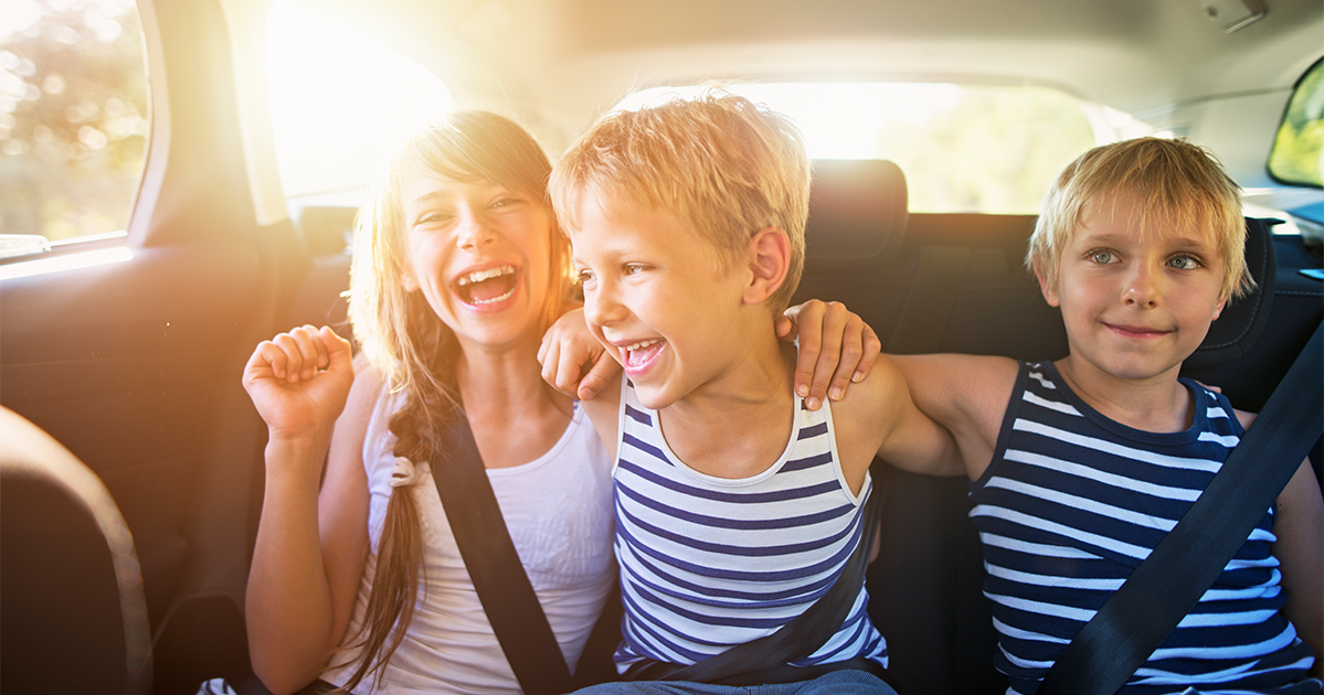 kids riding in a car laughing