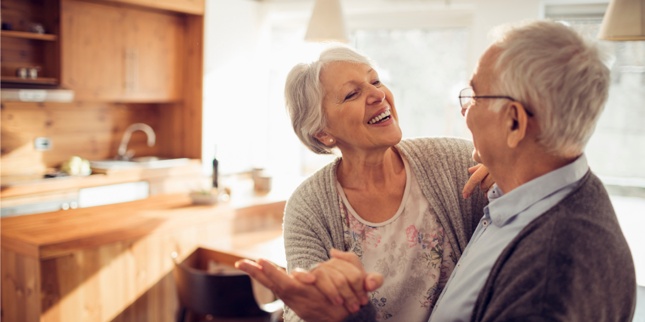 photo of older couple dancing in their kitchen