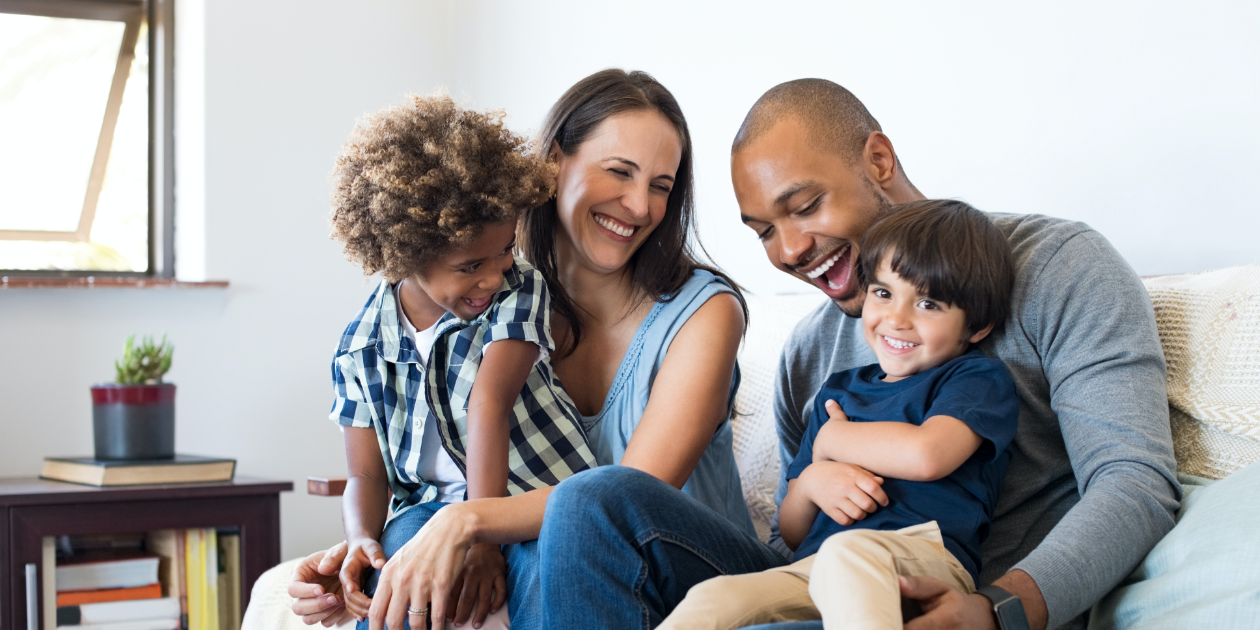 parents laughing with a young kid