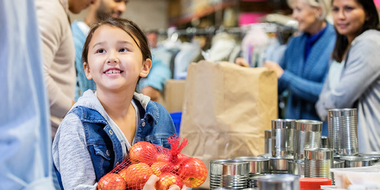 child packing food at food shelter