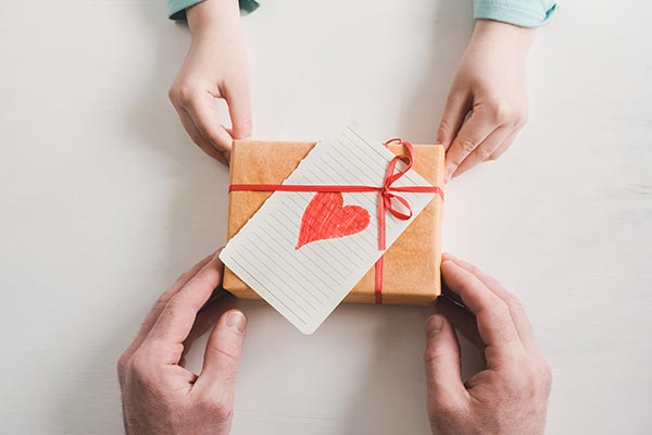 adult hands gift to child's hands