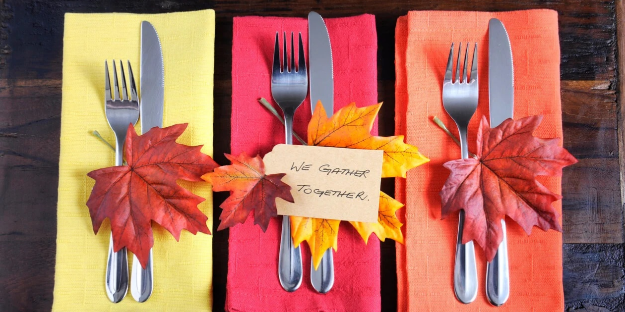 thanksgiving plates and silverware with tag saying: We Gather Together