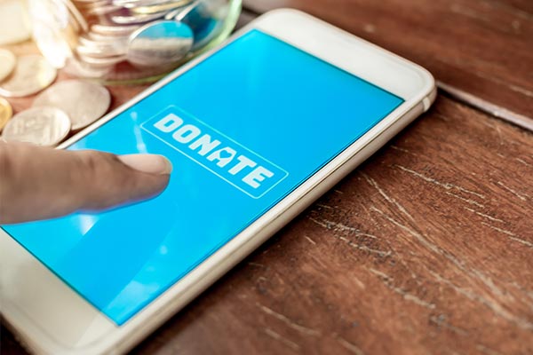 person clicking donate button on their phone