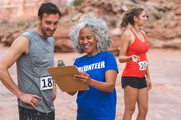 race runner registering for event holding clipboard