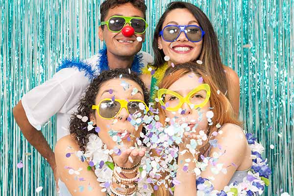 students dressed up blowing confetti to celebrate homecoming spirit week 