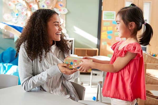 child giving teacher appreciation gift