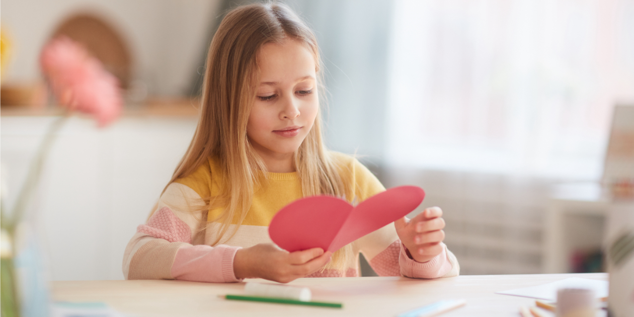 photo of girl holding a cut out heart