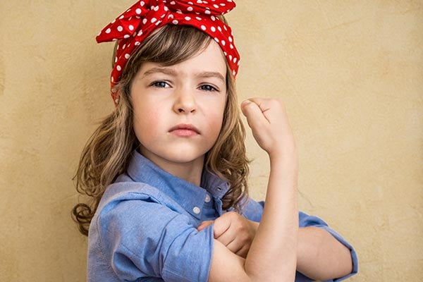 girl flexing arm to show strength