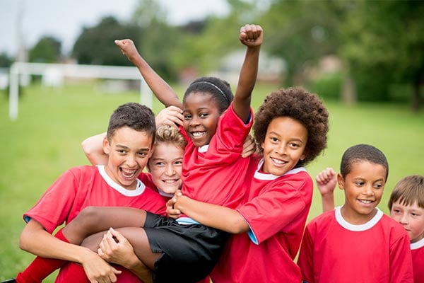 children soccer team celebrating victory together