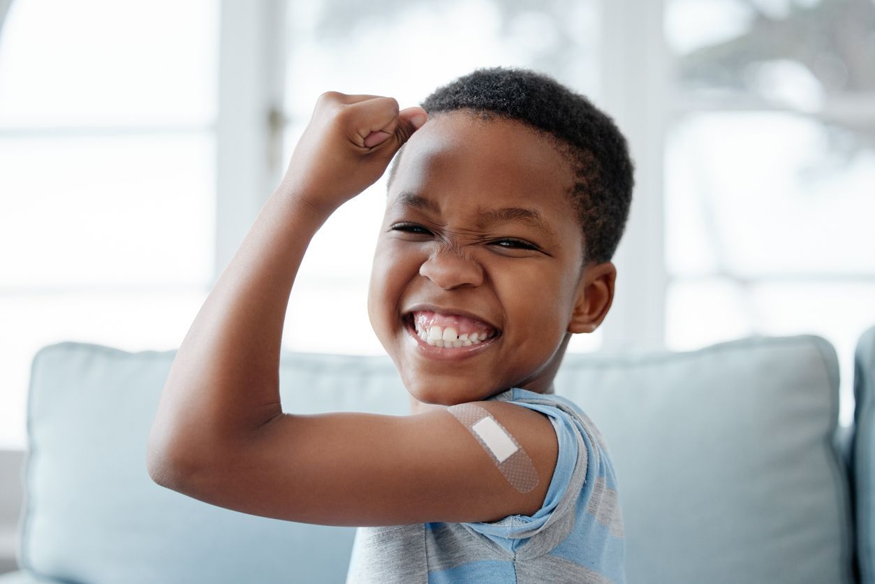 young child with band aid on arm