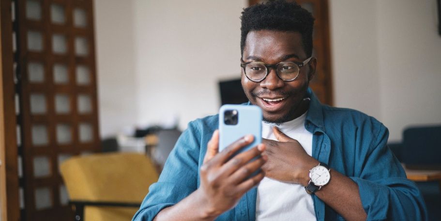 person on phone looking pleasantly surprised