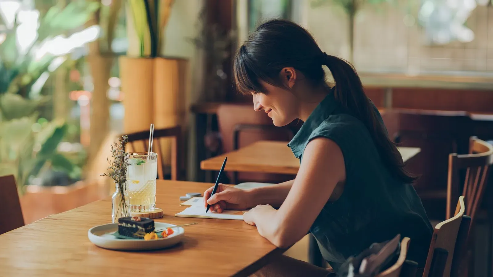woman writing at table